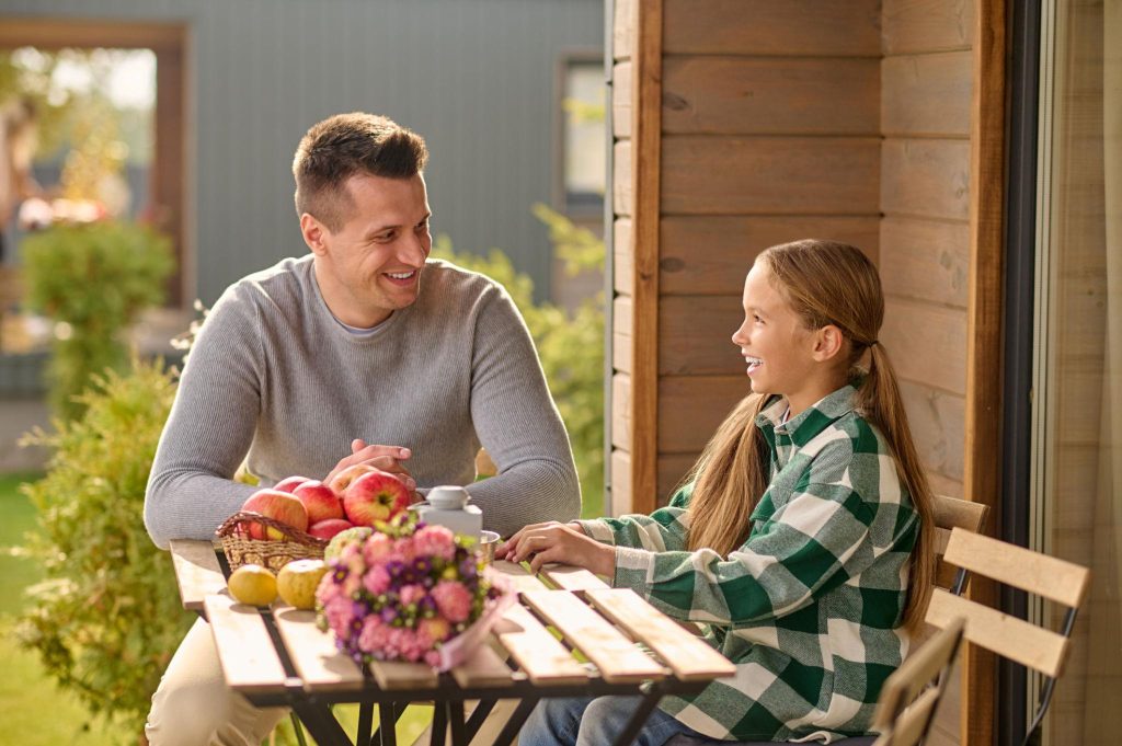 Adoptive father talking with his daughter about personal questions and adoption privacy